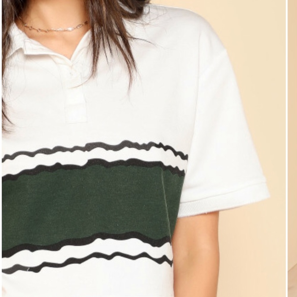 Cropped polo with green design.